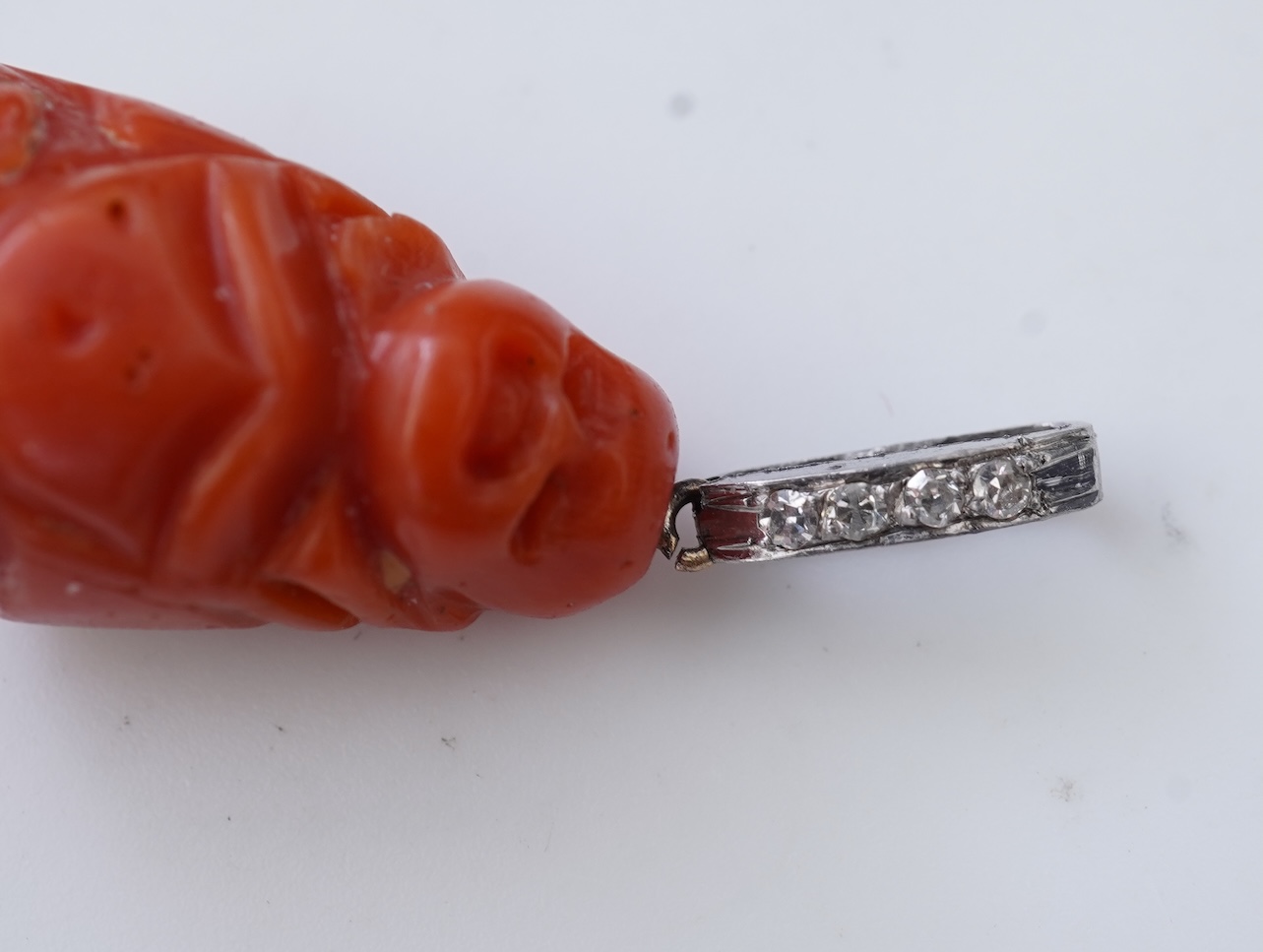 An Art Deco carved coral and diamond pendant, 1920s